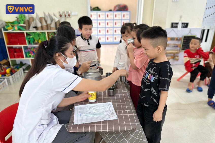 bé uống thuốc tẩy giun có tiêm phòng được không