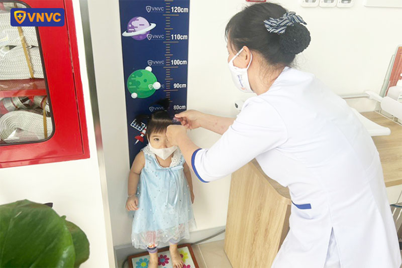 nhân viên vnvc phú mỹ đo chiều cao cho trẻ