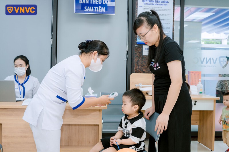 kiểm tra nhiệt độ trước khi tiêm phòng