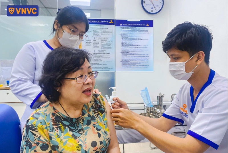 nhân viên y tế tiêm ngừa cho phụ nữ